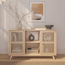 Modern Scandinavian sideboard with decorative vases, books, and wicker basket for minimalist home decor.