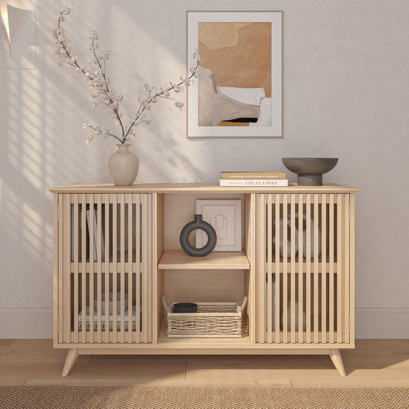 Modern Scandinavian sideboard with decorative vases, books, and wicker basket for minimalist home decor.
