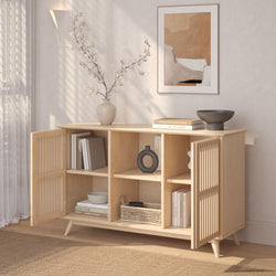 Modern wood sideboard with open shelves styled with books, decorative vase, and bowl in a minimalist living room setting.