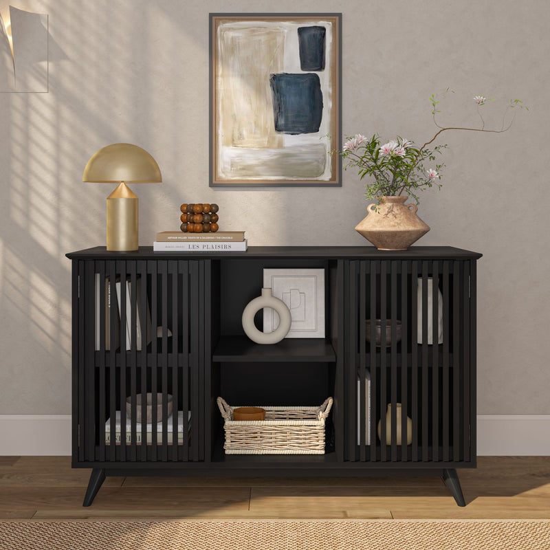 Modern black slatted console table in a styled entryway with gold mushroom lamp, abstract wall art, ceramic vase of pink flowers, wicker basket and decorative accents — mid-century modern home decor