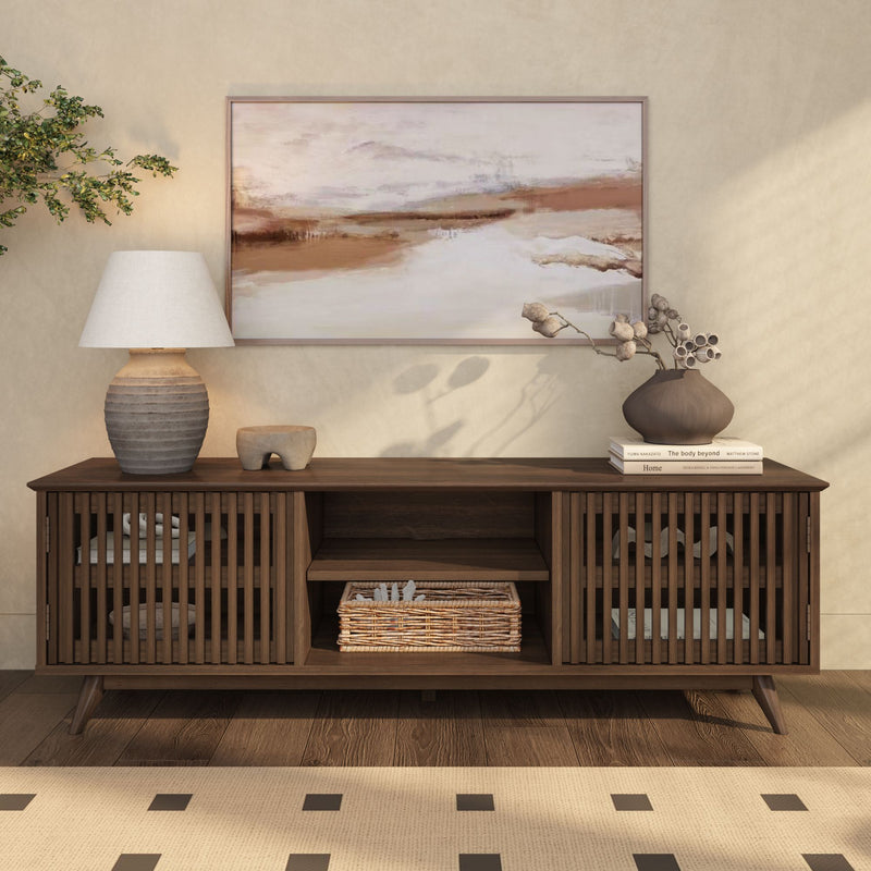 Mid-century modern wooden sideboard with decor items, including a ceramic lamp and abstract wall art, in a stylish living room setting.