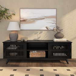 Sleek black wooden media console with decorative vases and lamp, enhancing modern living room interior design.