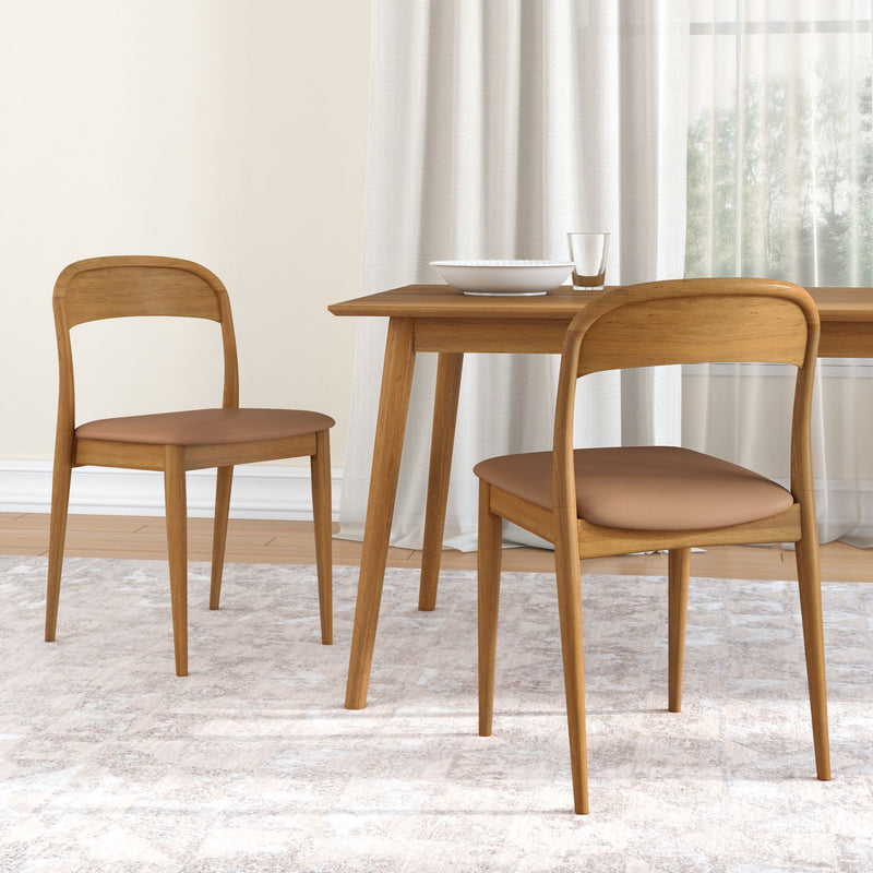 Mid-century modern wooden dining table set with two brown leather-upholstered chairs, neutral area rug and sheer curtains in a minimalist dining room.