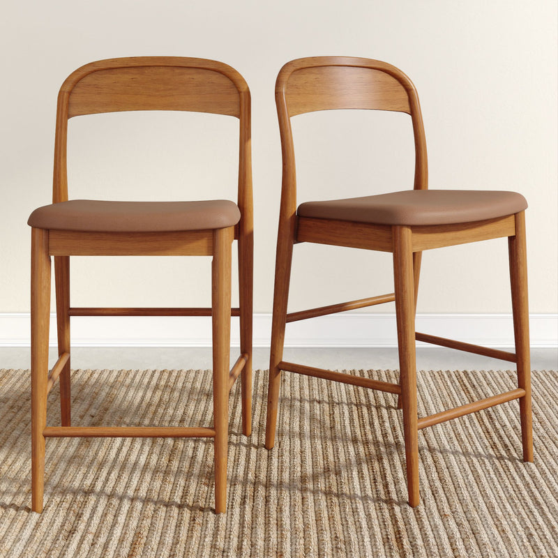 Pair of mid-century modern wooden bar stools with brown leather seats on woven jute rug, ideal for a kitchen island or breakfast bar