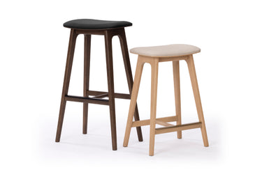 Wooden bar stools — modern pair: dark walnut with black upholstered seat and light oak with beige seat, tapered legs and footrest for kitchen island