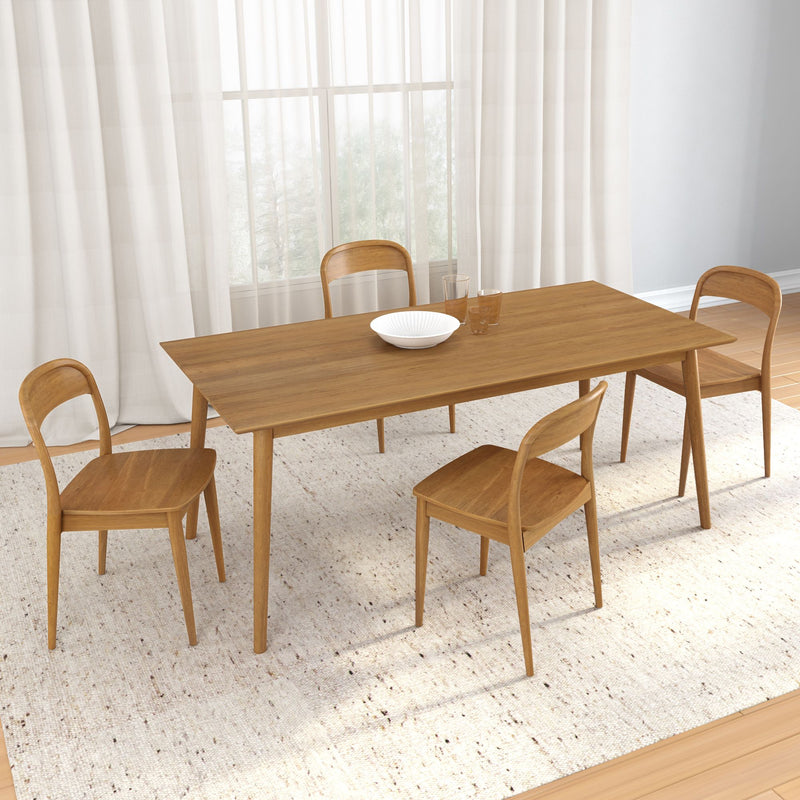 Modern wooden dining table set with four chairs and a decorative bowl in a bright dining room.