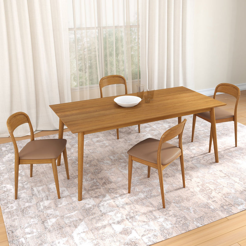 Mid-century modern wooden dining table set with four brown upholstered chairs on a textured beige area rug in a bright minimalist dining room with sheer curtains and a large window