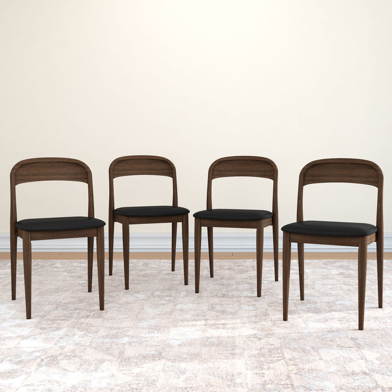 Set of 4 mid-century modern walnut dining chairs with black upholstered seats on a light area rug against a beige wall