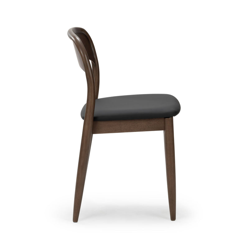 Mid-century walnut dining chair with black leather seat, curved backrest and tapered legs — side view on white background