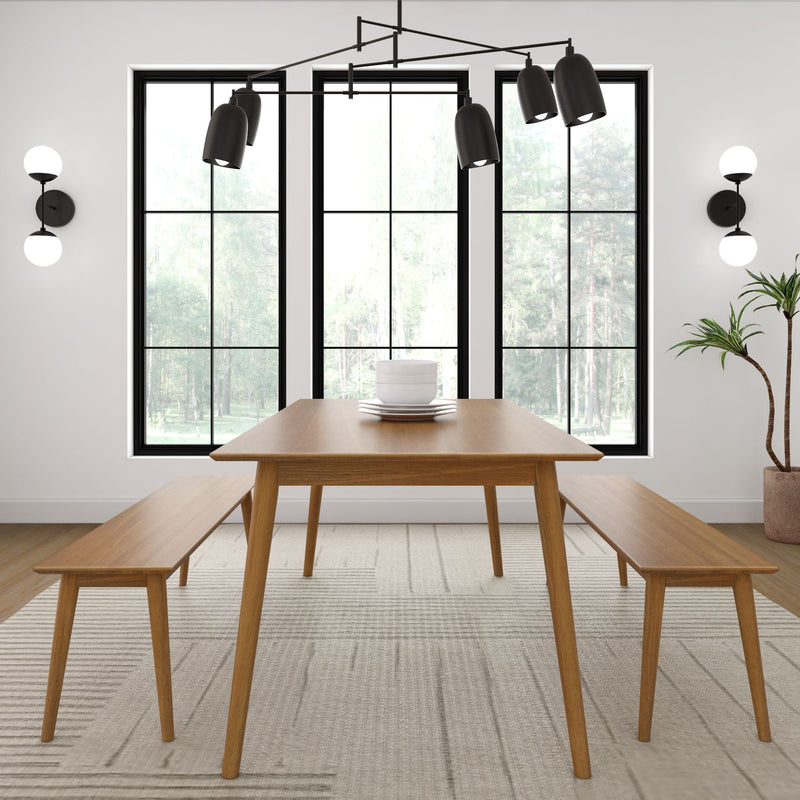 Modern dining room with wooden table and benches, large windows, stylish hanging light fixture, and indoor plant.