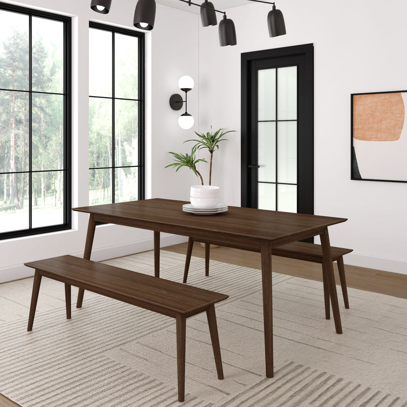 Modern dining room featuring a wooden table and benches, minimalist decor with houseplants and artistic wall accents.