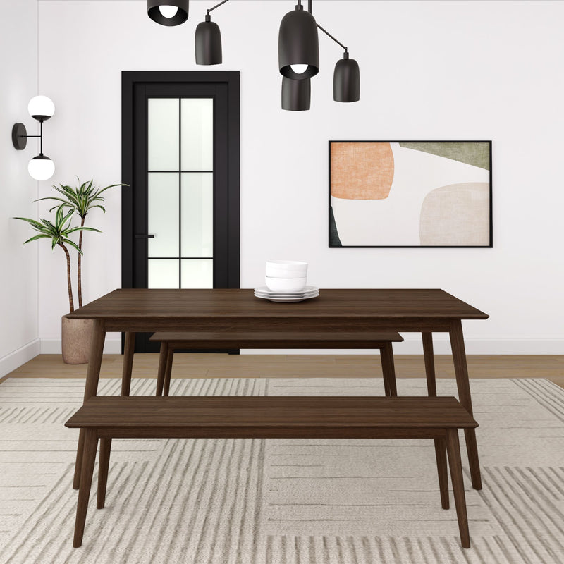 Modern dining room with sleek wooden table and bench, stylish black pendant lights, and contemporary art on the wall.