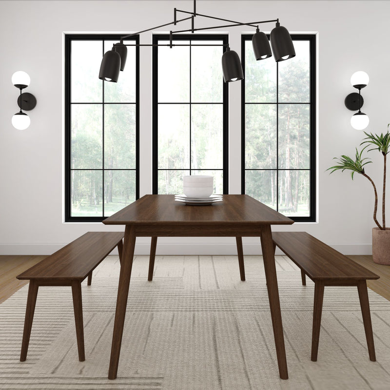 Minimalist dining room with a modern wooden table and benches, black pendant lighting, large windows, and white walls.