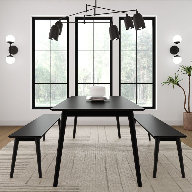 Modern dining room with black table, benches, large windows, and minimalistic decor.