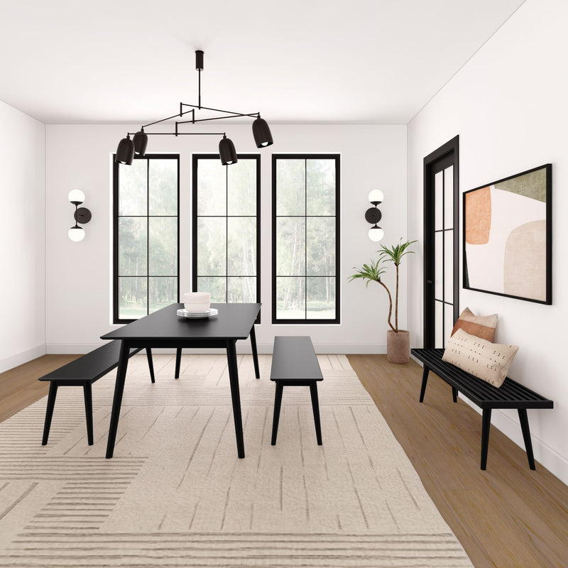 Modern dining room with black table and benches, featuring large windows and minimalist decor.