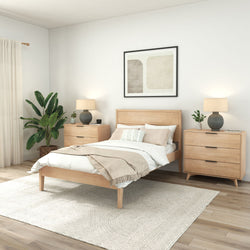 Modern bedroom with wooden furniture, white decor, and green plant for a serene ambiance.