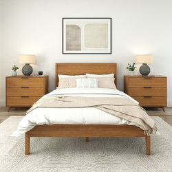 Mid-century modern bedroom with wooden bed frame and matching bedside tables featuring lamps and minimalist decor.