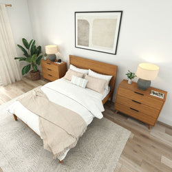 Cozy modern bedroom with wooden furniture, decorative plants, and soft neutral bedding.