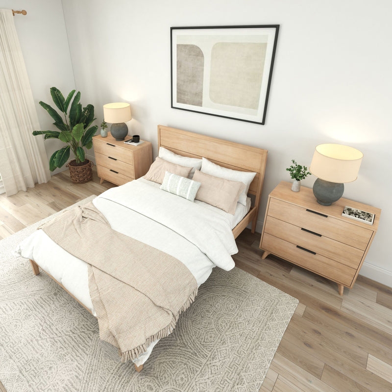 Cozy modern bedroom with wooden furniture, beige and white bedding, and decorative indoor plant.
