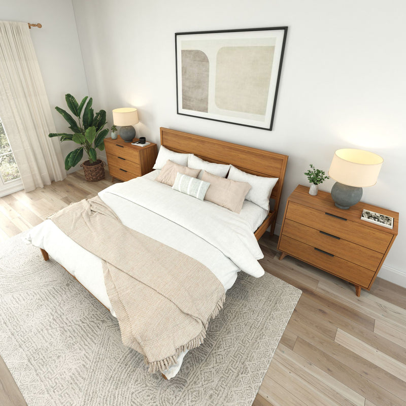 Modern bedroom interior with a wooden bed frame, stylish bedside tables, and cozy bedding.