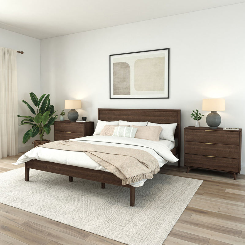 Modern mid-century bedroom with dark wood platform bed and matching nightstands, neutral linen bedding and throw, round table lamps, abstract wall art, indoor plant and textured area rug on light hardwood floors