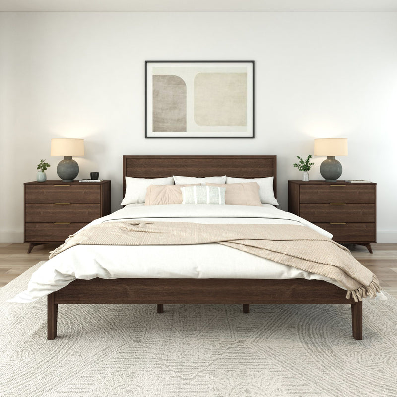Modern bedroom with wooden bed frame, cozy white bedding, and elegant nightstands featuring table lamps.