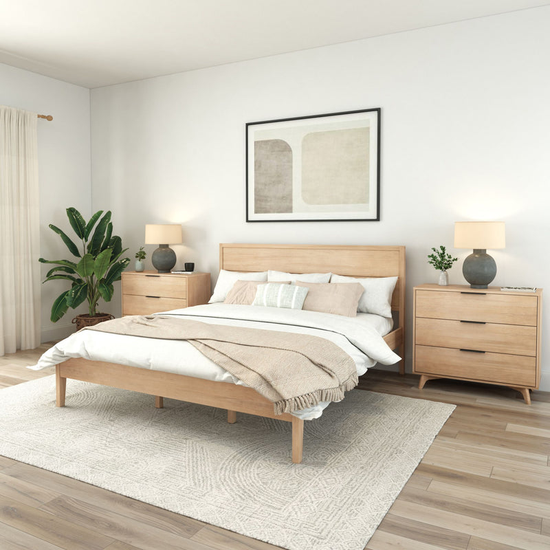 Modern Scandinavian bedroom with light wood platform bed, matching nightstands, neutral linen bedding, textured area rug, table lamps, indoor plant and abstract wall art