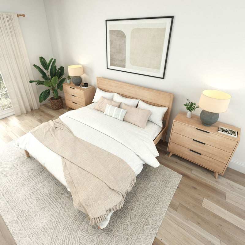 Cozy modern bedroom with wooden furniture, neutral bedding, and decorative plants.