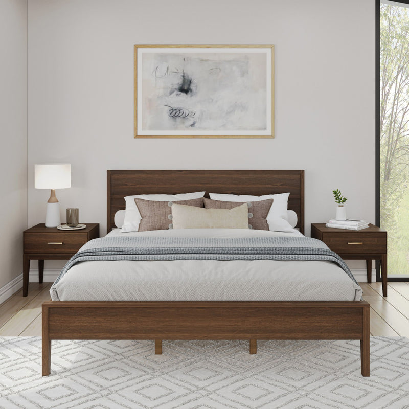 Modern bedroom with wooden bed frame, matching nightstands, and abstract wall art.