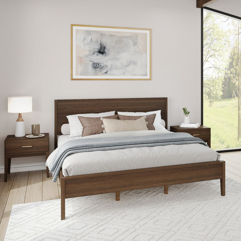Modern bedroom with wooden bed frame, stylish nightstands, cozy bedding, and large window showcasing natural light.