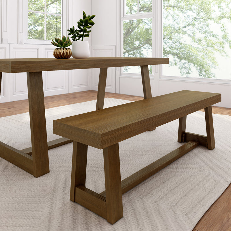 Modern farmhouse oak dining table and bench with succulent centerpiece by large sunlit windows in a bright minimalist dining room