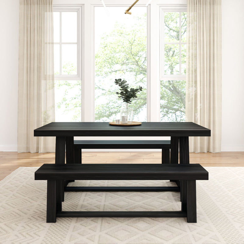 Modern dining room with black wood table and benches in bright space with large windows and beige curtains.