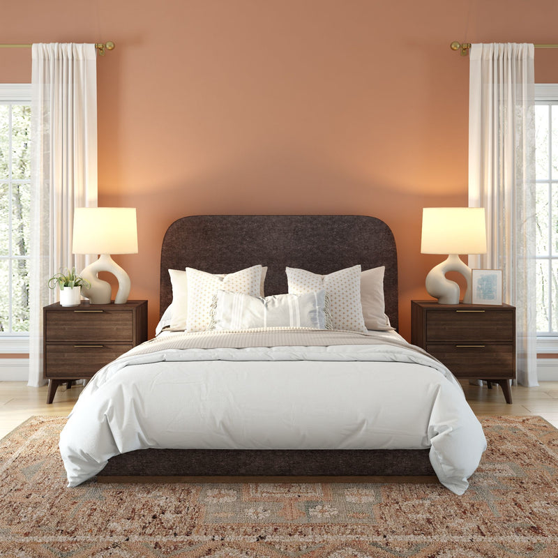 Modern bedroom with brown accent wall, white bedding, and wood nightstands.