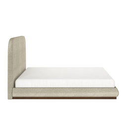Modern beige upholstered low-profile platform bed with rounded tall headboard and dark wood base, minimalist bedroom furniture