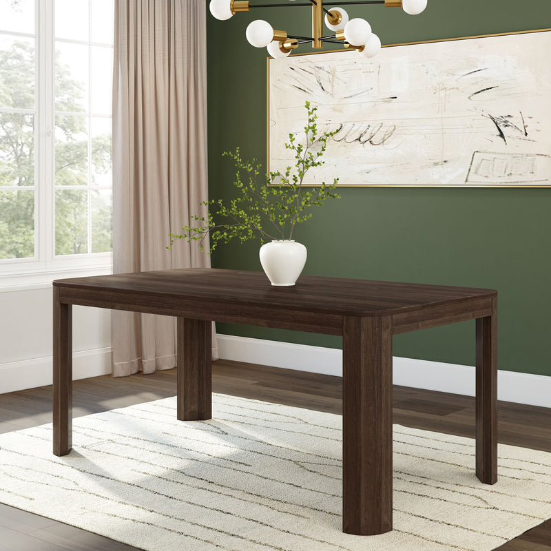 Elegant dark wood dining table with white vase centerpiece in modern dining room.