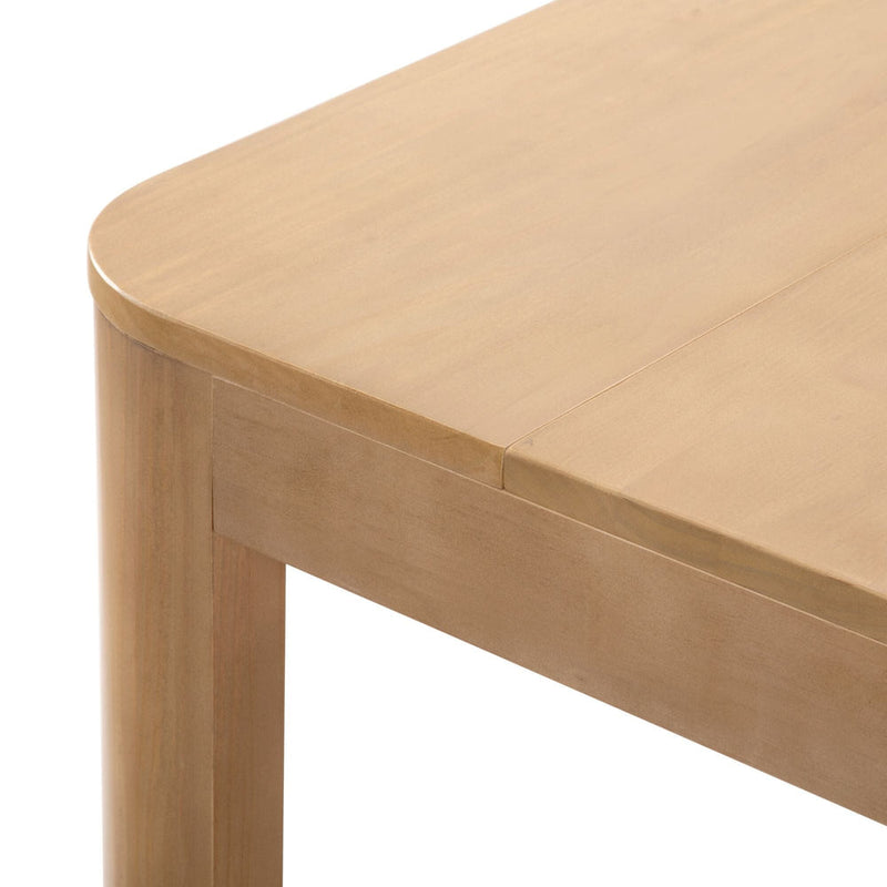 Close-up of a wooden dining table corner, showcasing the smooth finish and natural wood grain.
