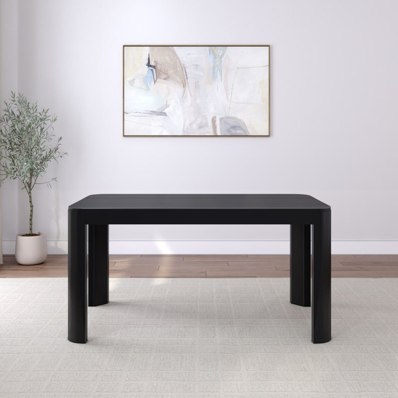 Modern black dining table in a minimalist room with abstract art and a potted plant.