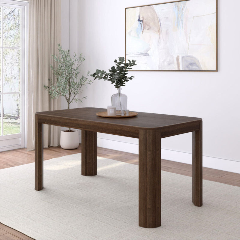 Modern dining room with a dark wood table, light rug, and abstract wall art.