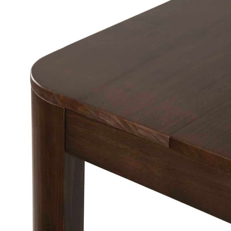 Dark wood dining table corner with smooth finish and rounded edges.