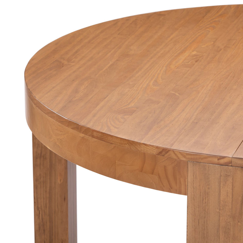 Round wooden dining table with a smooth surface and sturdy legs.