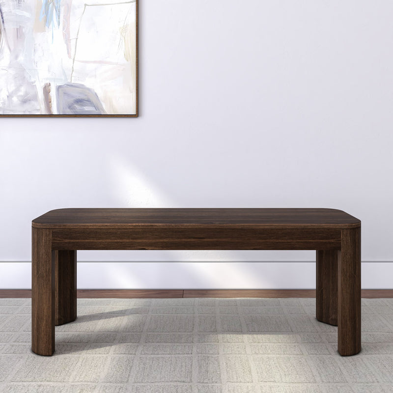 Dark wooden bench in modern minimalist living room setting with abstract wall art.