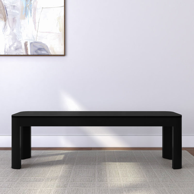Modern black bench in minimalist living space with abstract wall art.