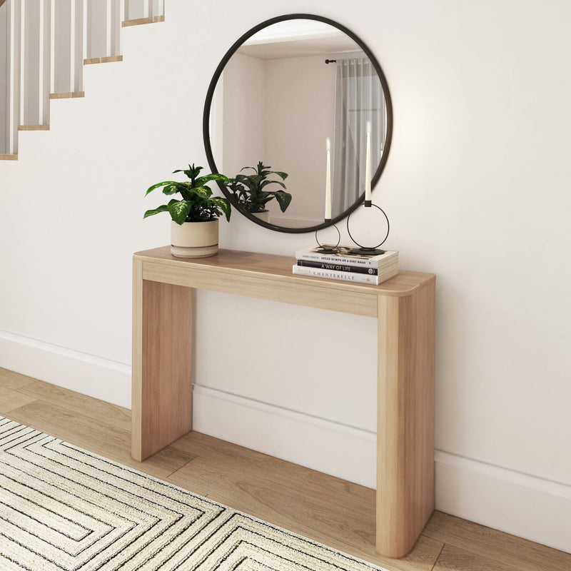 Modern wooden console table with decorative mirror and indoor plant in minimalist entryway.