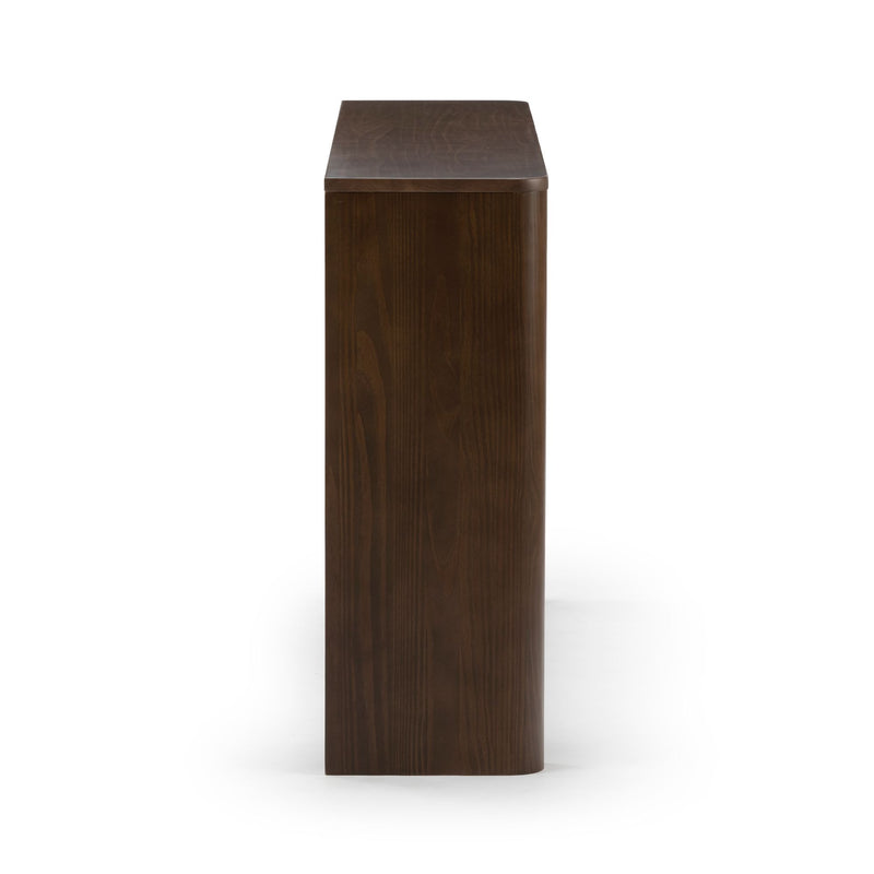 Side view of modern wooden office desk, dark finish.