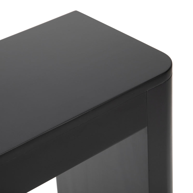Black wooden table corner with smooth finish and modern design.