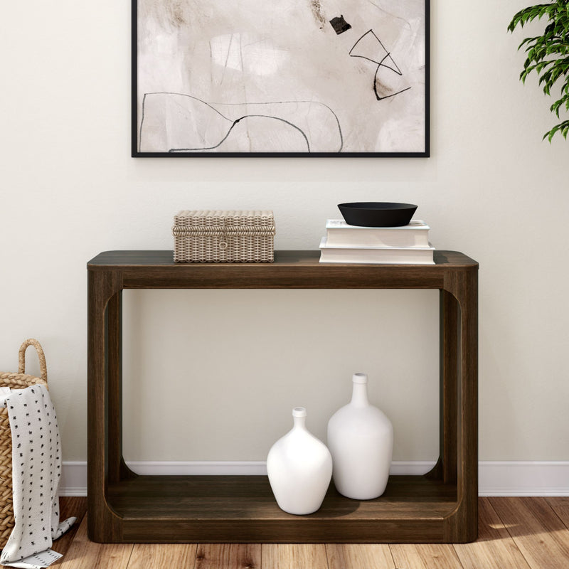 Modern console table with decorative items, abstract wall art, and wood floor.