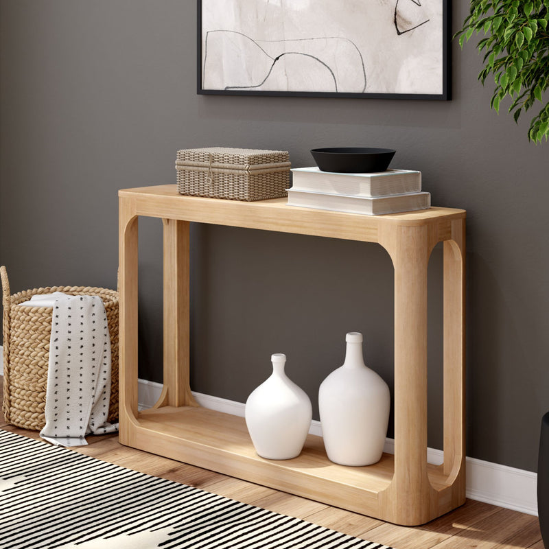Stylish modern wooden console table with decorative items, wall art, and striped rug in a cozy living room setting.