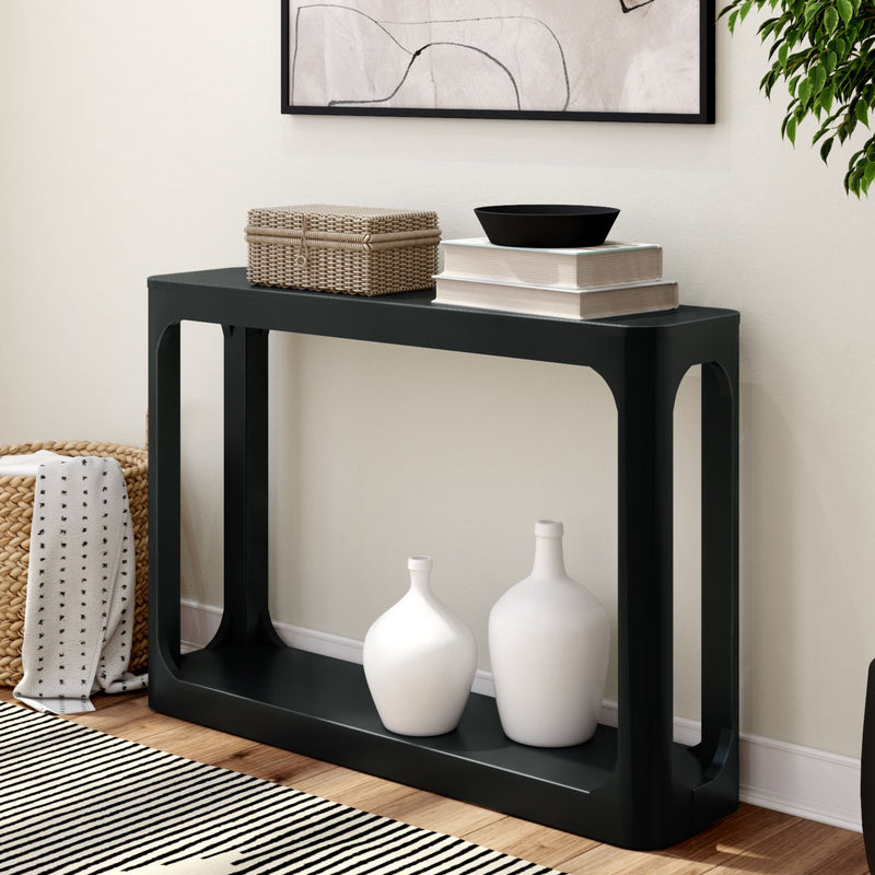 Modern black console table with decorative items and minimalist decor in a stylish living room.