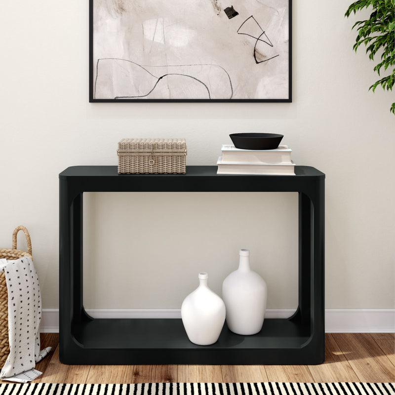 Modern black console table with decorative vases and wicker basket in stylish living room setting.