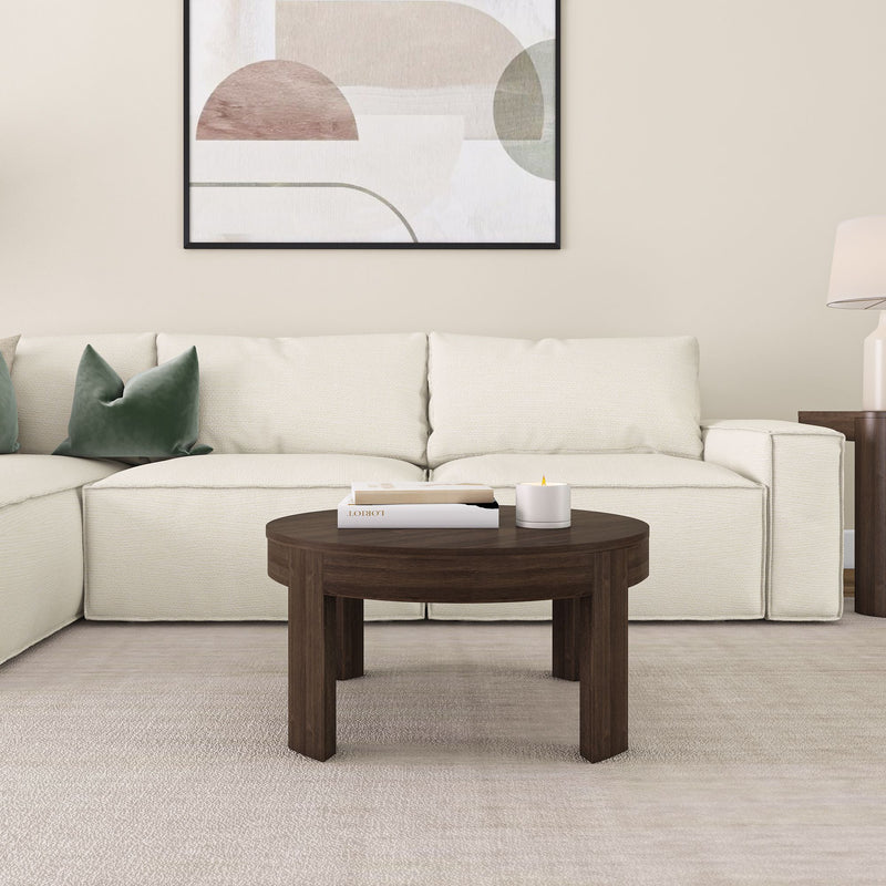 Modern living room with a white sectional sofa, dark wood coffee table, and abstract wall art.